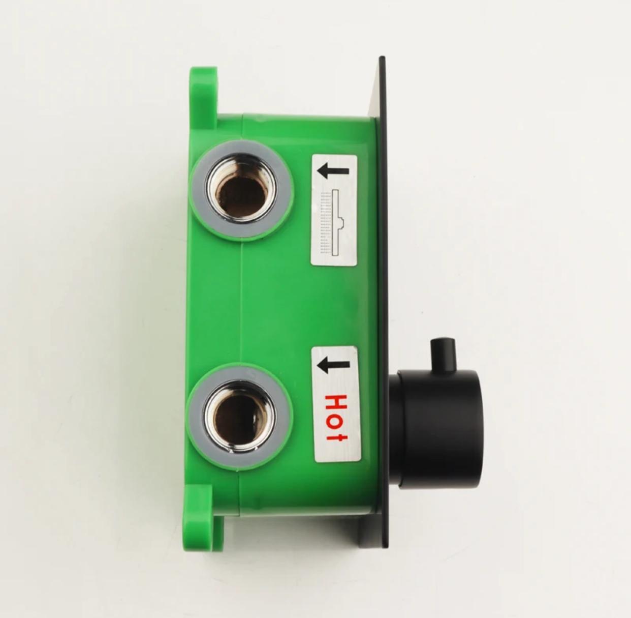 Side view of a 2-function thermostatic shower valve with matte black faceplate and temperature knob, green ABS rough-in box and threaded water connections.