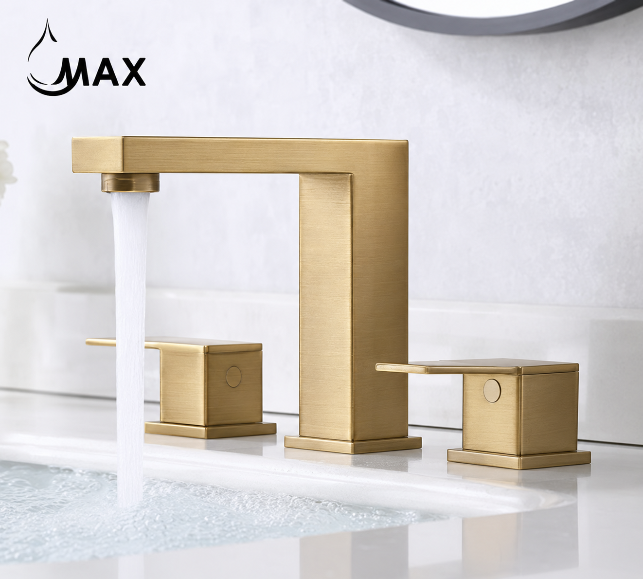 A modern wide-mount bathroom faucet in brushed gold finish, shown with water running from the spout and two matching handles on a white sink against a light gray wall. The brand name 'MAX' is visible in the top left corner.