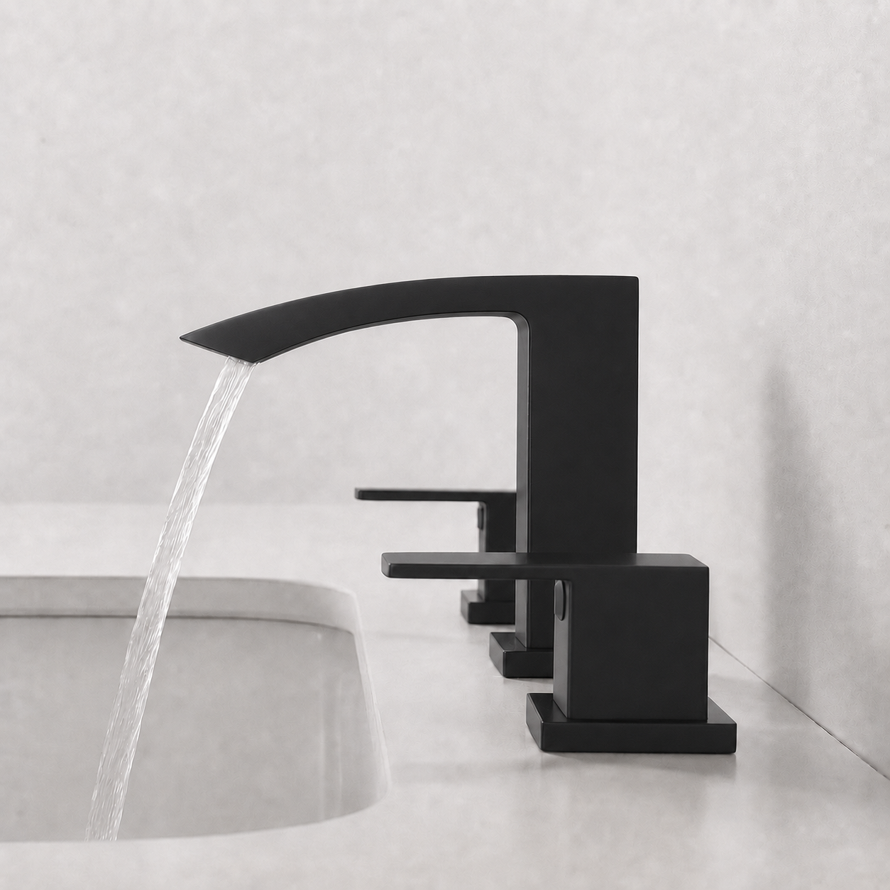 A matte black three-hole wall-mounted faucet with a curved spout and single lever handle, shown with water flowing into a light gray sink against a textured light gray wall.