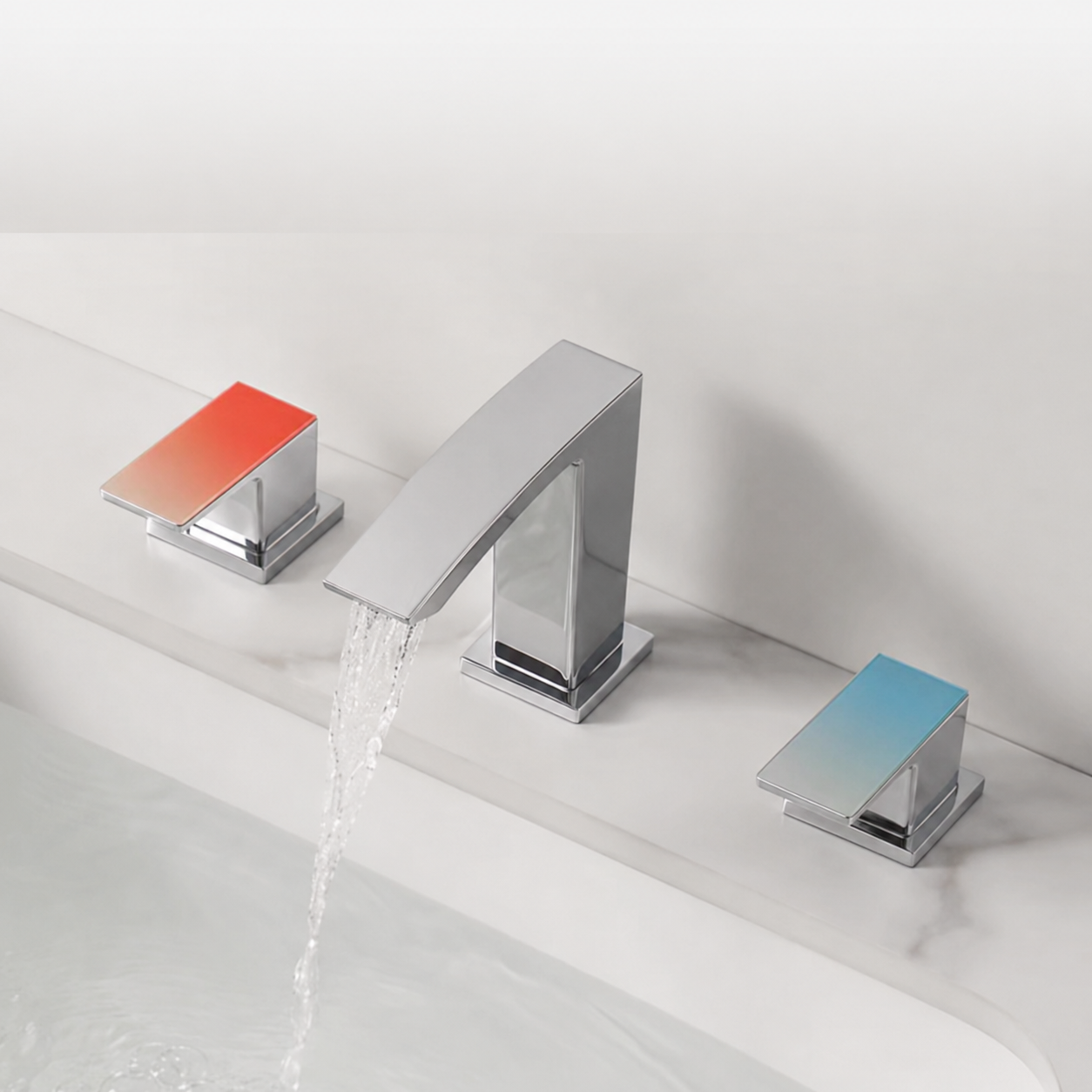 A modern three-hole bathroom faucet set with a central chrome gooseneck spout and two matching square handles, one with a red-to-blue gradient and one with a blue-to-red gradient, shown installed on a white marble sink with water running from the spout.