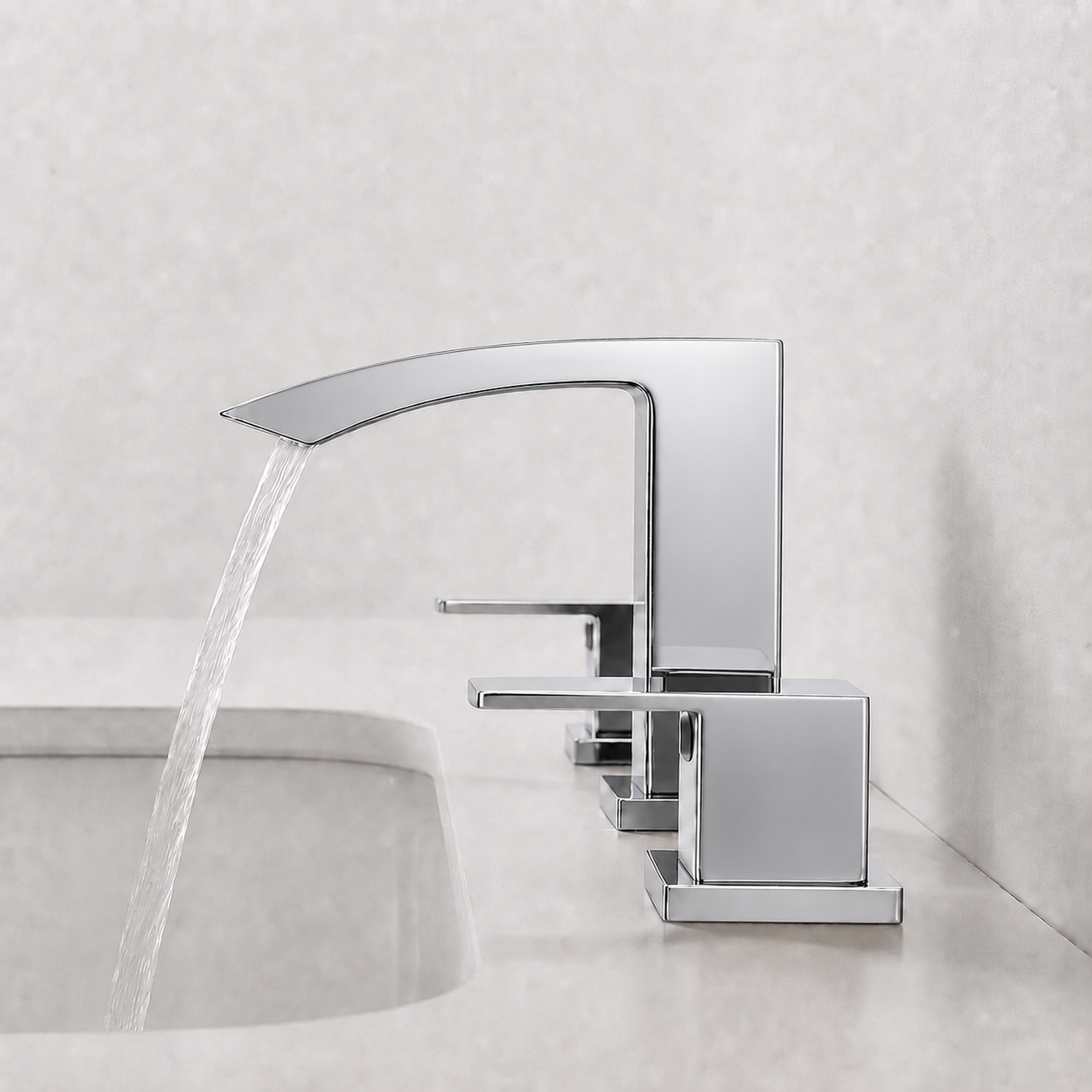 A modern single-handle bathroom faucet with a polished chrome finish, shown with water flowing from the spout into a sink. The faucet has a square-shaped backplate and lever handle, set against a light gray tiled wall and countertop.