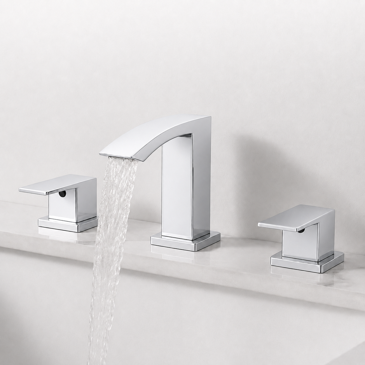 A modern three-hole bathroom faucet set with a polished chrome finish, featuring a central curved spout with water flowing out and two matching lever handles on either side, installed on a white marble countertop against a light gray wall.