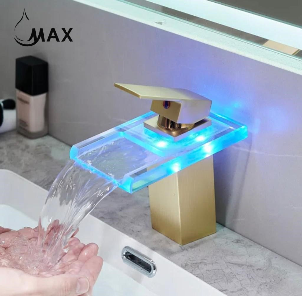 Gold faucet with LED lighting dispensing water into a sink, brand 'MAX' visible.