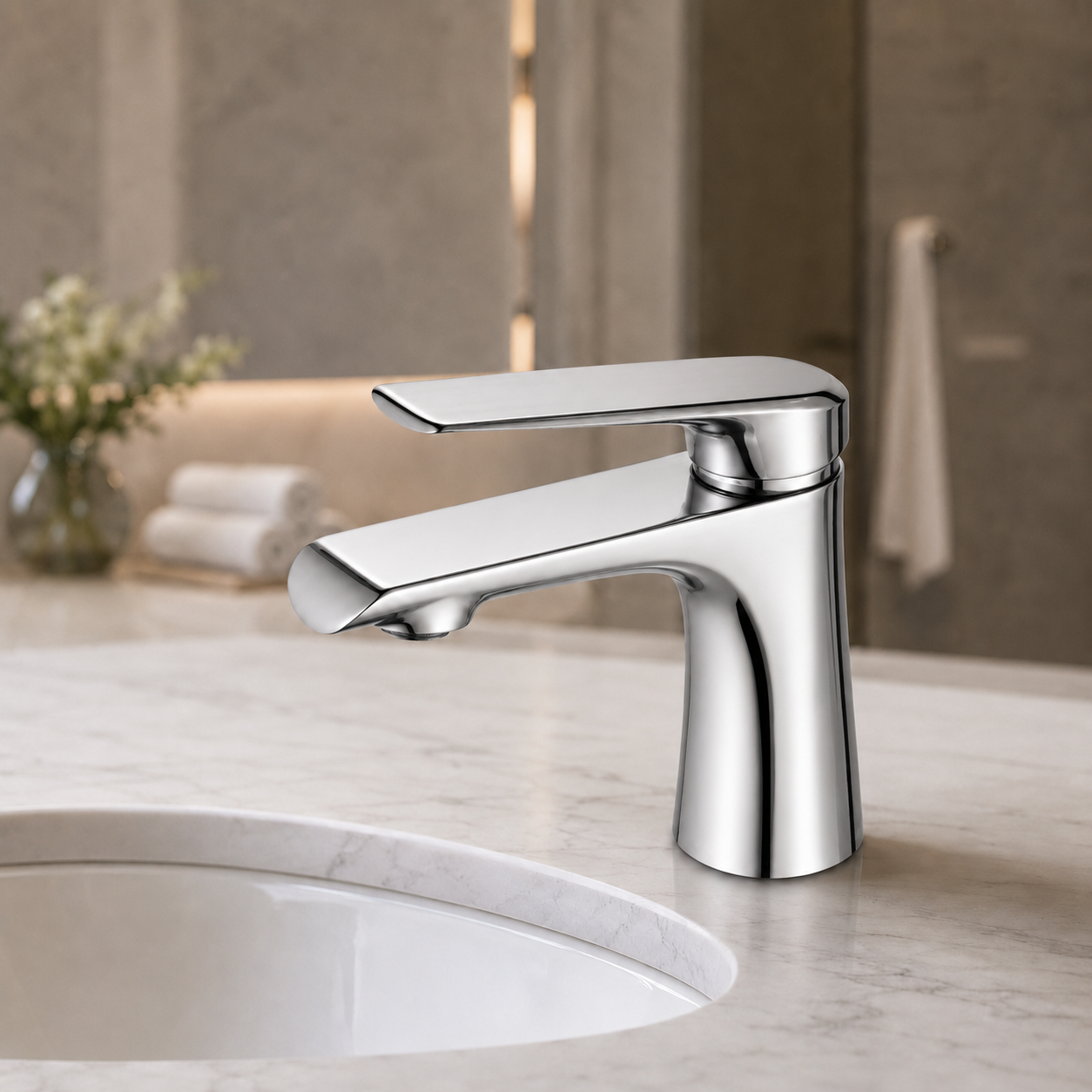 A modern single-handle bathroom faucet with a polished chrome finish, mounted on a white marble sink countertop with a blurred bathroom background.