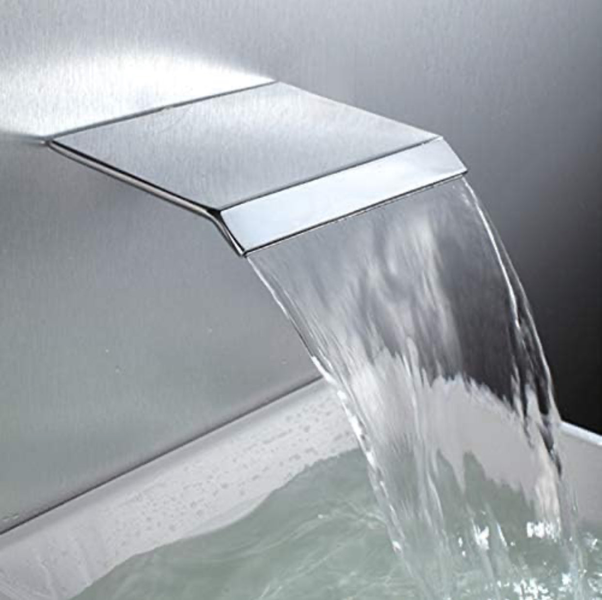 Wide chrome waterfall tub spout with smooth cascading water flow
