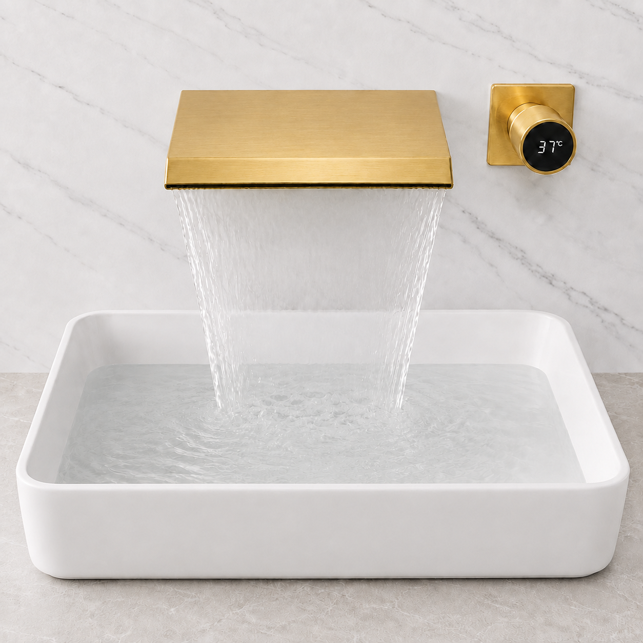 A modern wall-mounted waterfall faucet in brushed gold with a rectangular white ceramic basin underneath, set against a light marble wall and countertop.