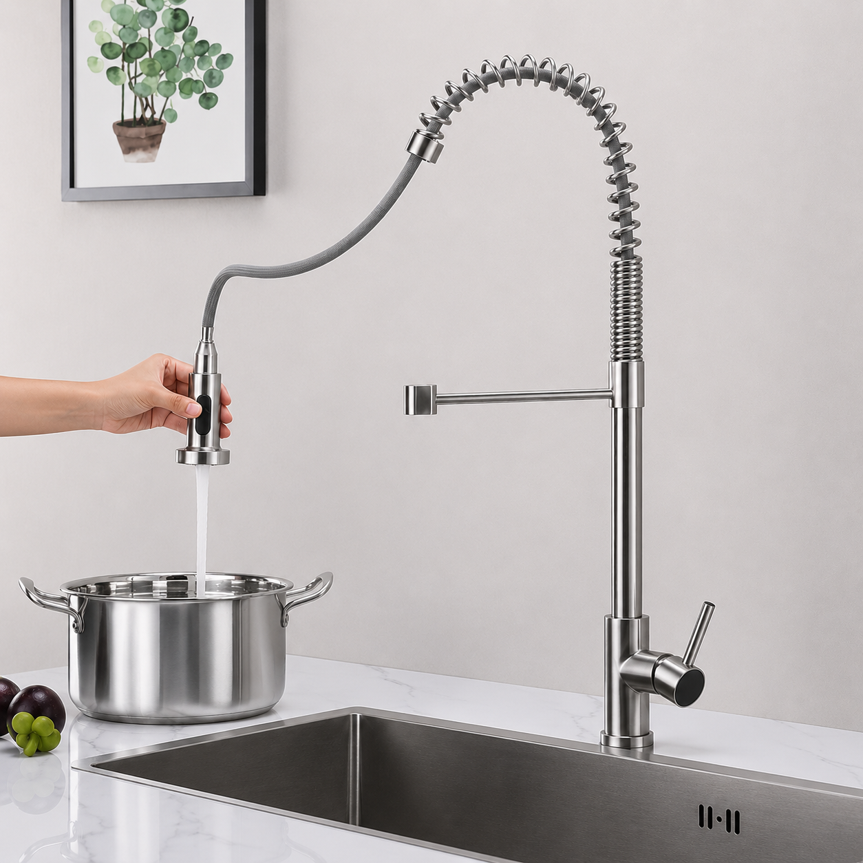 Commercial style pull-down kitchen faucet filling a cooking pot with flexible retractable spray head