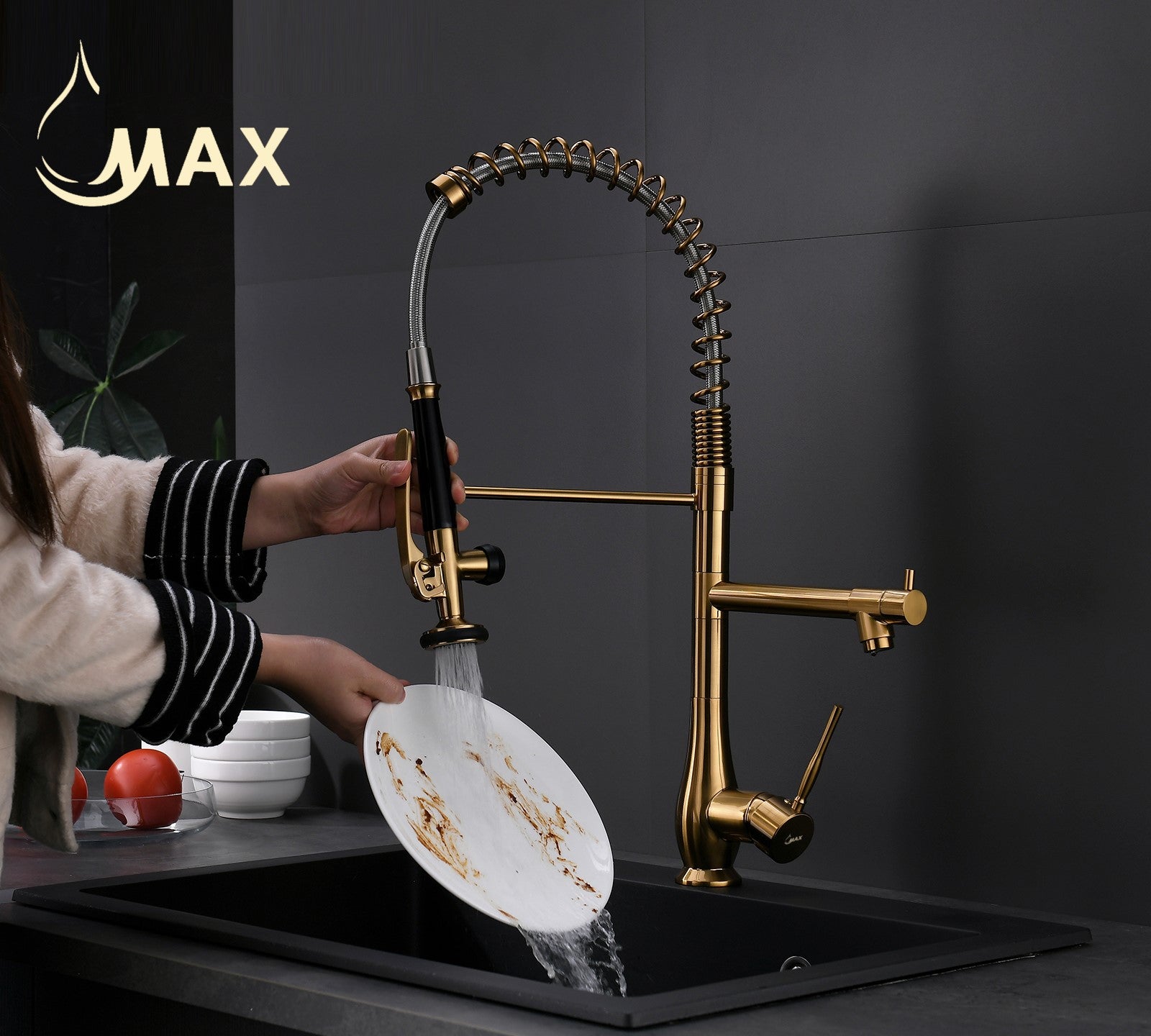 Close-up of MAX Faucets brushed gold pre-rinse sprayer nozzle in powerful spray mode