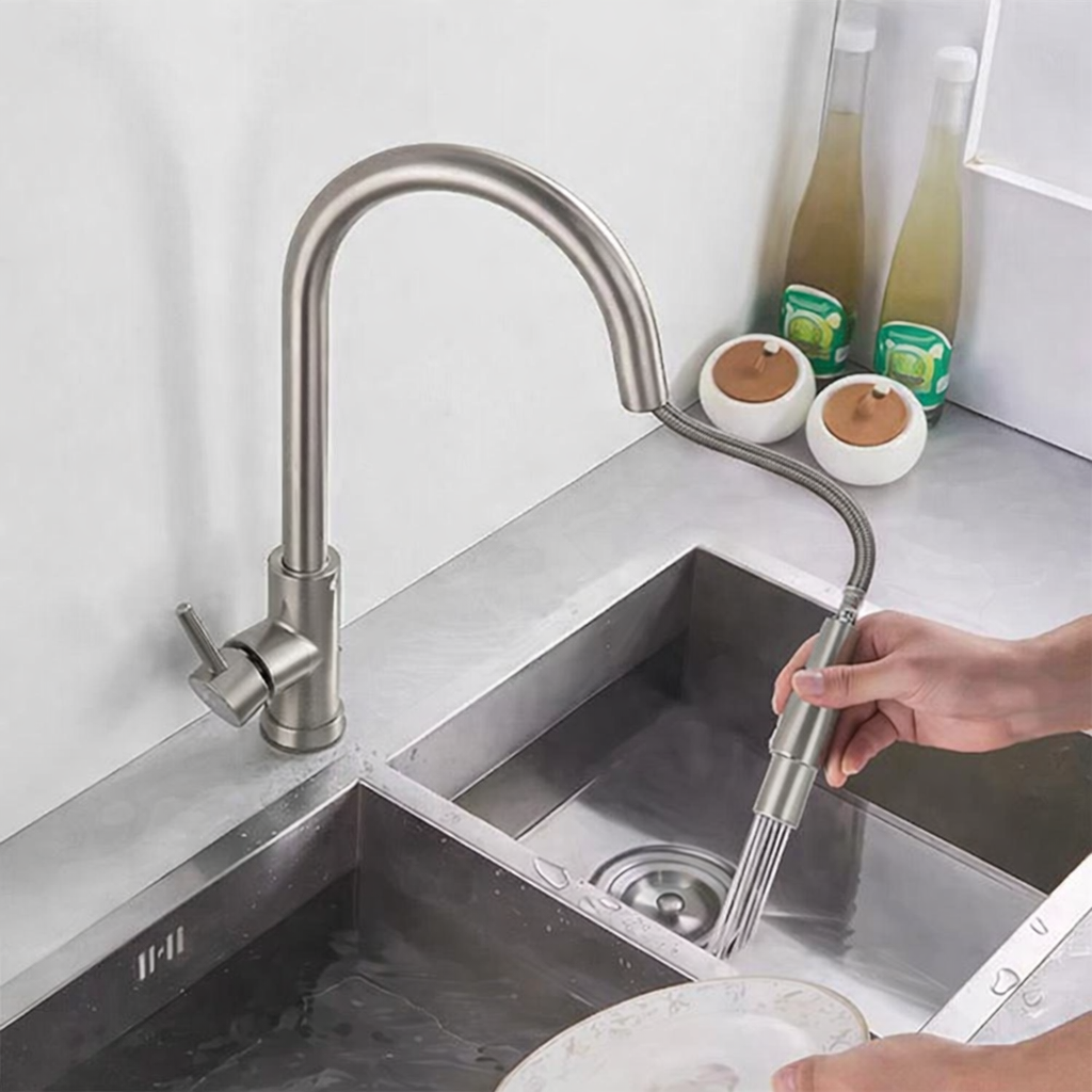 Close-up of brushed nickel kitchen faucet spray head and flexible hose