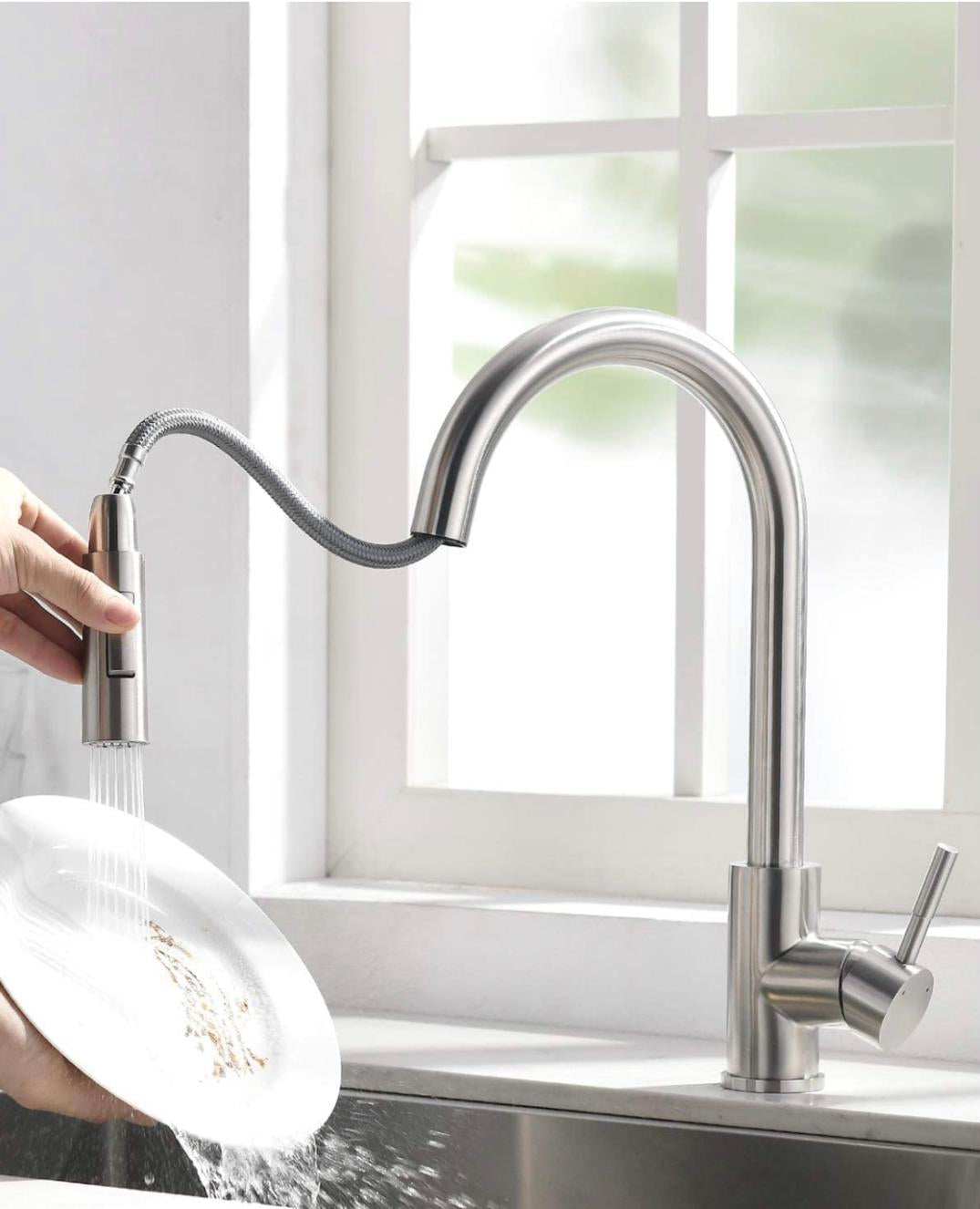 Pull-out kitchen faucet in brushed nickel finish with high-arc design by MAX Faucets installed over a stainless steel sink