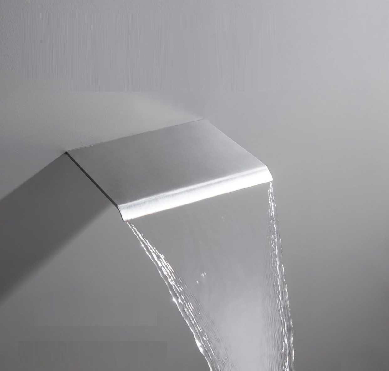 Modern shower head with water flowing against a gray background