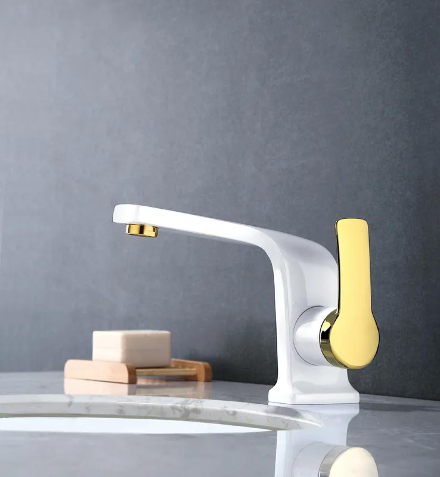 White and shiny gold bathroom faucet installed on modern vanity by MAX Faucets