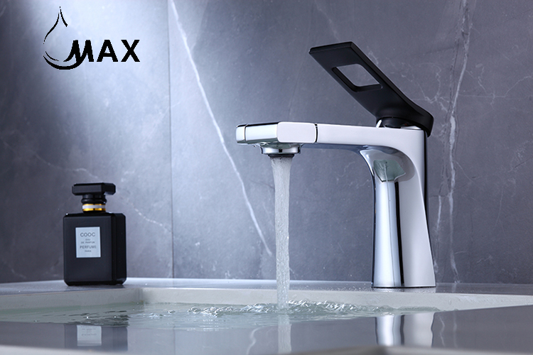 Modern silver faucet with water flowing, against a gray marble background, featuring the brand 'MAX'.