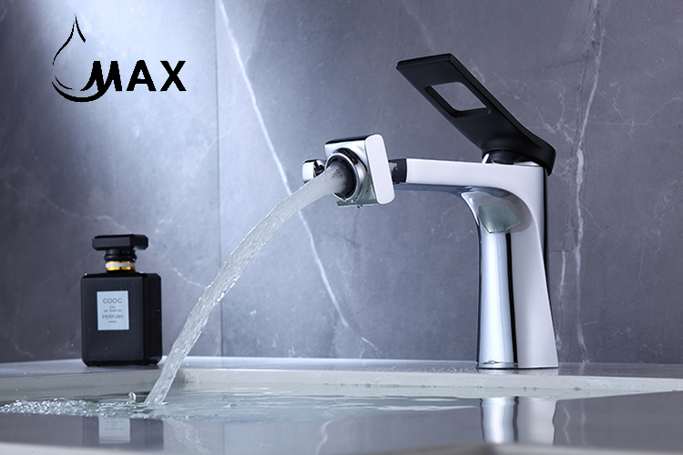 Modern silver faucet with water flowing, against a gray marble background, featuring the brand 'MAX'.