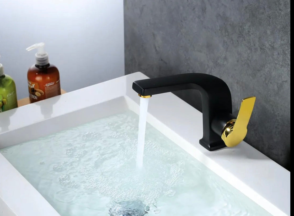 Matte black and shiny gold bathroom faucet with smooth water flow on modern vanity by MAX