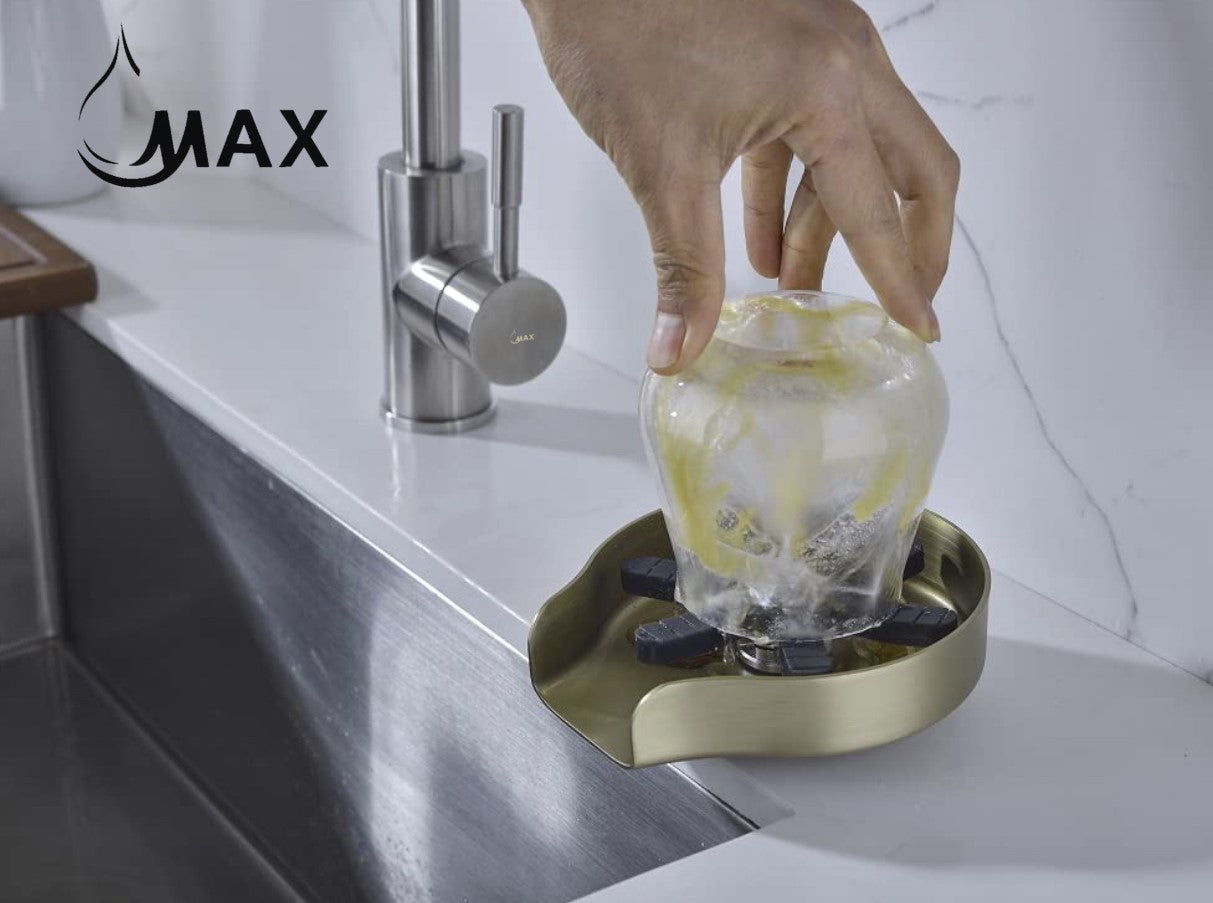 Brushed gold rotating kitchen sink cup washer rinsing a glass