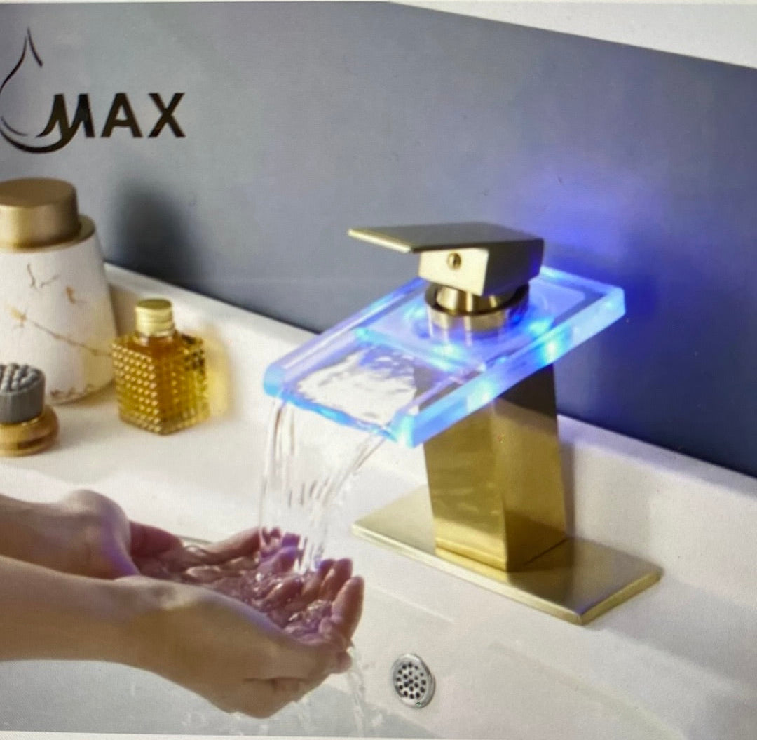 Gold faucet with LED lighting dispensing water into a sink, brand 'MAX' visible.